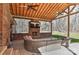 Relaxing covered patio featuring brick fireplace, ceiling fans, and comfortable wicker furniture at 9414 Machado Dr, Indian Trail, NC 28079