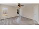 Spacious bedroom with plush carpet, a modern ceiling fan, and windows offering ample natural light at 9534 Blossom Hill Dr, Huntersville, NC 28078