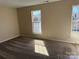 Bright bedroom with carpeted floors, two large windows, and neutral walls offering a cozy space at 9534 Blossom Hill Dr, Huntersville, NC 28078