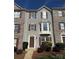 Charming townhome with gray siding, brown shutters, and a bay window showcasing a welcoming facade at 9534 Blossom Hill Dr, Huntersville, NC 28078