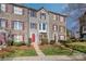 A well-maintained townhome showcasing a blend of brick and siding, complemented by lush greenery and a walkway at 9534 Blossom Hill Dr, Huntersville, NC 28078