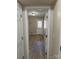 Inviting hallway with hardwood floors leading to a bright room with a glass-paneled door at 9534 Blossom Hill Dr, Huntersville, NC 28078
