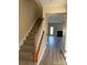 Bright foyer and stairway with carpeted steps and laminate flooring leading to living area at 9534 Blossom Hill Dr, Huntersville, NC 28078