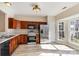 Well-lit kitchen with stainless steel appliances, dark wood cabinets and a bright breakfast nook by the window at 9534 Blossom Hill Dr, Huntersville, NC 28078
