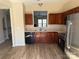 Spacious kitchen featuring wood cabinets, modern appliances, a double sink, and new laminate flooring at 9534 Blossom Hill Dr, Huntersville, NC 28078
