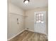 Spacious laundry room with vinyl flooring, a wire shelf, and an exterior door at 9534 Blossom Hill Dr, Huntersville, NC 28078