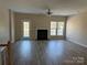 Spacious living room featuring a fireplace, hardwood floors, and a ceiling fan at 9534 Blossom Hill Dr, Huntersville, NC 28078