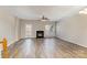 Spacious living room features hardwood floors, a fireplace, and a ceiling fan creating a comfortable atmosphere at 9534 Blossom Hill Dr, Huntersville, NC 28078