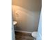 Cozy powder room featuring stylish flooring, a pedestal sink, and a modern toilet at 9534 Blossom Hill Dr, Huntersville, NC 28078