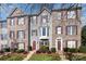 Charming townhome with brick and siding, featuring red shutters and manicured landscaping for curb appeal at 9534 Blossom Hill Dr, Huntersville, NC 28078