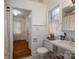 A charming bathroom with a black-and-white tiled floor, white wainscoting, and classic fixtures at 1120 Cumberland Ave, Gastonia, NC 28054
