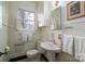 Classic bathroom with pedestal sink, tiled floor, and window with natural light at 1120 Cumberland Ave, Gastonia, NC 28054