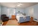 Cozy bedroom with a blue-painted bed frame, hardwood floors, and a comfortable leather armchair at 1120 Cumberland Ave, Gastonia, NC 28054