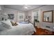 Light-filled bedroom with hardwood floors, comfortable queen bed, and two window at 1120 Cumberland Ave, Gastonia, NC 28054