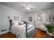 Cozy bedroom featuring hardwood floors, natural light, and a comfortable chair at 1120 Cumberland Ave, Gastonia, NC 28054
