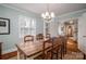 Charming dining room featuring a large wooden table and views into the adjacent wallpapered room at 1120 Cumberland Ave, Gastonia, NC 28054
