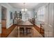 Traditional dining room features a rustic table, chandelier lighting, and built-in shelving at 1120 Cumberland Ave, Gastonia, NC 28054