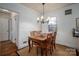 Cozy dining room with a wooden table, chairs, rug, and natural light from the window at 1120 Cumberland Ave, Gastonia, NC 28054