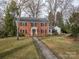 Charming two-story brick home with classic design and mature landscaping creating a welcoming curb appeal at 1120 Cumberland Ave, Gastonia, NC 28054
