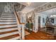 Hallway with a staircase, decorative wallpaper, hardwood floors, and entryways to other rooms at 1120 Cumberland Ave, Gastonia, NC 28054