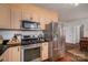 Modern kitchen with stainless steel appliances, gas range, and adjacent dining area at 1120 Cumberland Ave, Gastonia, NC 28054