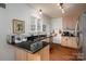 Bright kitchen with black countertops, light wood cabinets, and stainless steel appliances at 1120 Cumberland Ave, Gastonia, NC 28054
