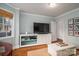 Comfortable living room with large TV, white media console, and neutral color palette at 1120 Cumberland Ave, Gastonia, NC 28054