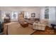Bright living room with hardwood floors, neutral walls, large windows, and comfortable furniture for relaxation at 1120 Cumberland Ave, Gastonia, NC 28054