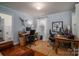 Dual office space featuring rustic wooden desks, comfortable seating, and hardwood floors at 1120 Cumberland Ave, Gastonia, NC 28054