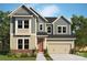 Charming two-story home with a mix of vertical and horizontal siding and a two car garage at 11205 Shreveport Dr, Huntersville, NC