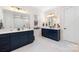 Modern bathroom featuring double sinks, sleek vanity, and elegant mirrors, creating a spa-like experience at 118 Golden Trl, Mooresville, NC 28115