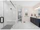 This primary bathroom features a walk-in shower with seat and a navy blue vanity with double sinks at 118 Golden Trl, Mooresville, NC 28115