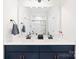 This bathroom features a navy blue vanity with double sinks and modern hardware and a large mirror at 118 Golden Trl, Mooresville, NC 28115