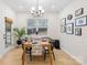 Bright dining room featuring a wooden table, modern chandelier, and a large window view at 118 Golden Trl, Mooresville, NC 28115