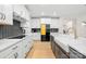 Modern kitchen with white cabinets, gray island with white countertop, and stainless steel appliances at 118 Golden Trl, Mooresville, NC 28115