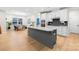 Bright, open kitchen with island, breakfast bar, stainless appliances, and access to dining area at 118 Golden Trl, Mooresville, NC 28115
