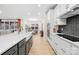 Modern kitchen featuring a gray island, white cabinets, and stainless steel appliances at 118 Golden Trl, Mooresville, NC 28115