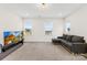 Spacious living room featuring plush carpeting, ample seating, and natural light at 118 Golden Trl, Mooresville, NC 28115