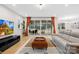 Comfortable living room with large glass doors to the outside, a TV, and a gray leather couch at 118 Golden Trl, Mooresville, NC 28115