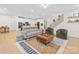 Spacious open-concept living room with kitchen, staircase, seating, and a stylish area rug at 118 Golden Trl, Mooresville, NC 28115