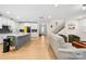 Bright, open-concept living room featuring a modern kitchen, staircase, and stylish decor at 118 Golden Trl, Mooresville, NC 28115