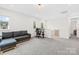 Versatile loft area with a comfortable couch, desk setup, and plenty of natural light at 118 Golden Trl, Mooresville, NC 28115