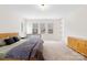 Spacious main bedroom featuring multiple windows, a crib, and neutral decor at 118 Golden Trl, Mooresville, NC 28115