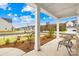 Inviting covered porch with ample seating and views of the landscaped front yard at 118 Golden Trl, Mooresville, NC 28115