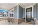 Charming covered porch with seating, complemented by brick accents and lush landscaping at 118 Golden Trl, Mooresville, NC 28115