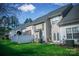 Exterior view of the backyard featuring a green lawn and private patio at 11907 Maria Ester Ct, Charlotte, NC 28277