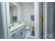 Clean bathroom featuring painted vanity with modern hardware, toilet, and patterned floor mat at 11907 Maria Ester Ct, Charlotte, NC 28277