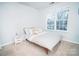 Bright bedroom with a large window, comfortable bed, and minimalistic decor at 11907 Maria Ester Ct, Charlotte, NC 28277