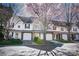 Street view of multi-unit townhomes with garages, landscaping, and well-maintained lawns at 11907 Maria Ester Ct, Charlotte, NC 28277
