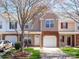 Charming townhome with brick accents, attached garage, and a well-maintained lawn at 11907 Maria Ester Ct, Charlotte, NC 28277